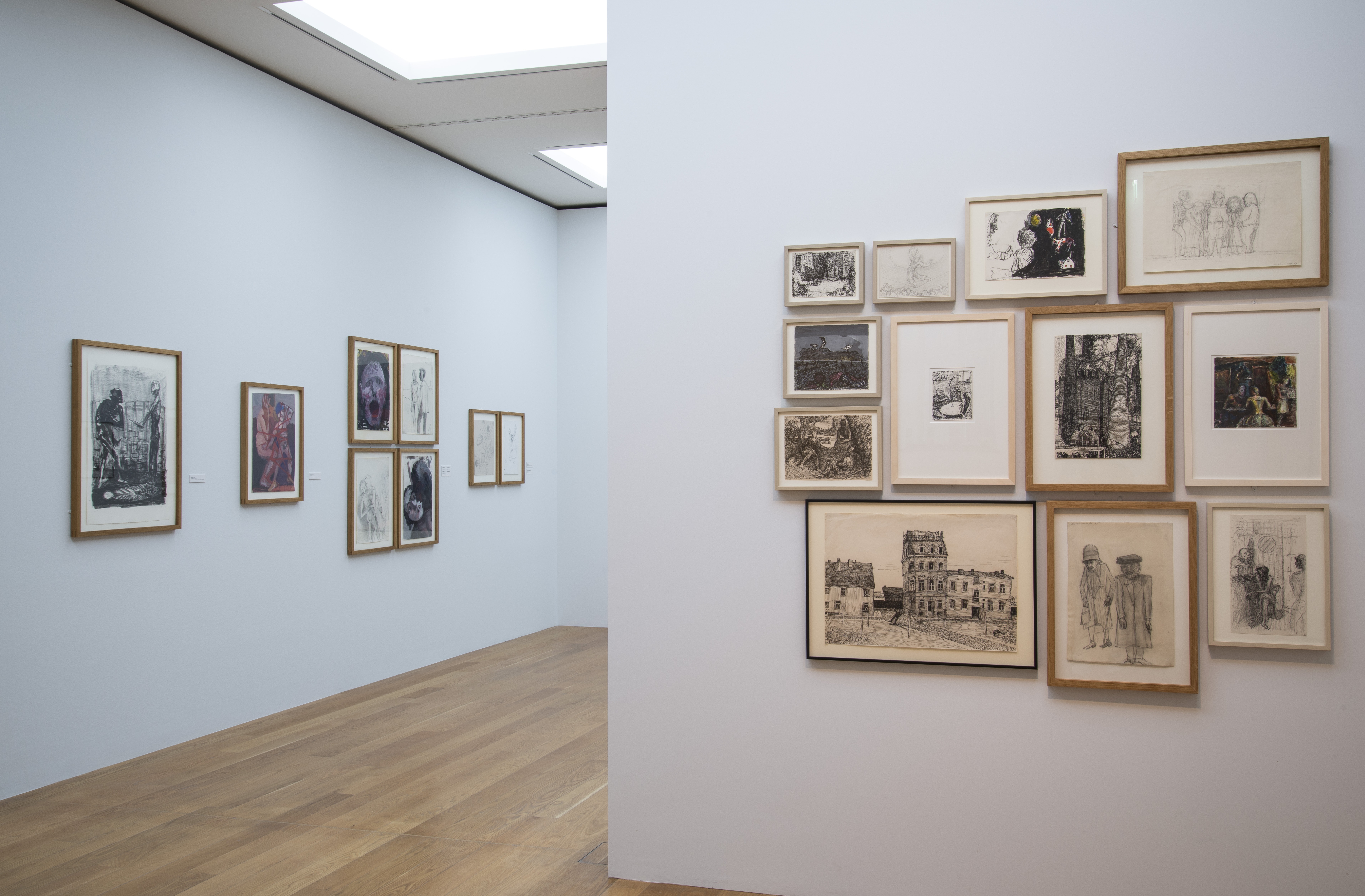 AI generated: The image shows a gallery with numerous framed works of art hanging on white walls. The room has a wooden floor and a modern, minimalist atmosphere.