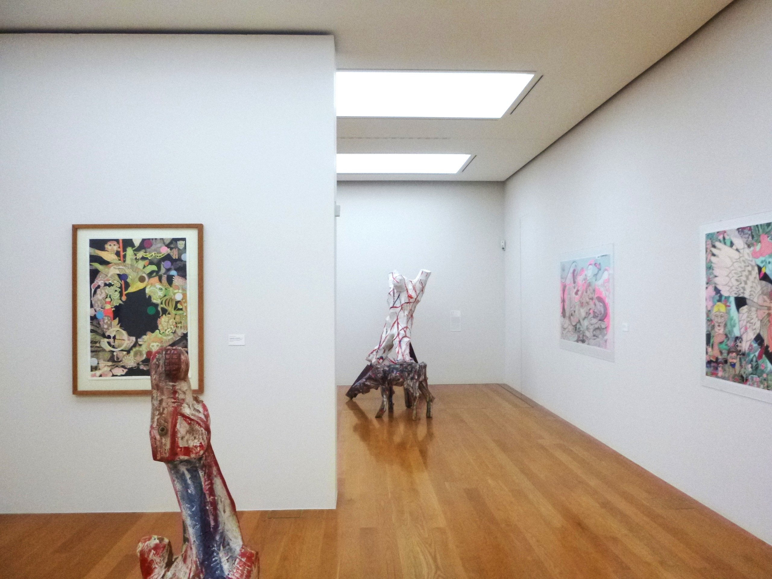 AI generated: The image shows a modern gallery space with colourful art on the walls and abstract sculptures on the floor. The room is brightly lit and the exhibits are at the centre of the presentation.