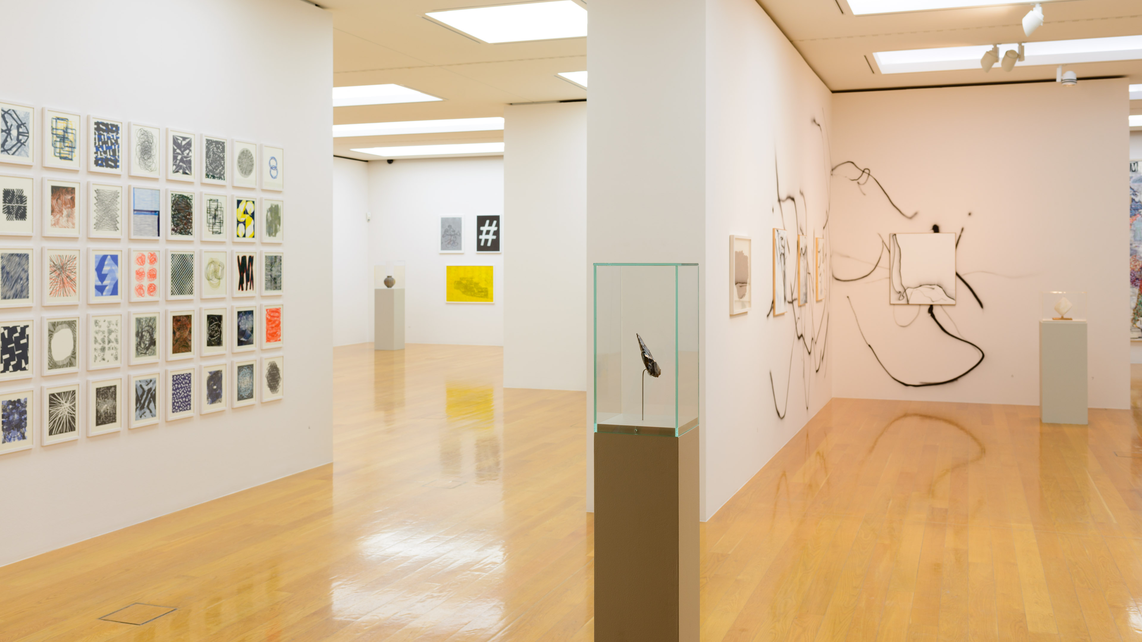 AI generated: The image shows a gallery with three different paintings on white walls. The paintings vary in size and style and are displayed on a wooden floor.